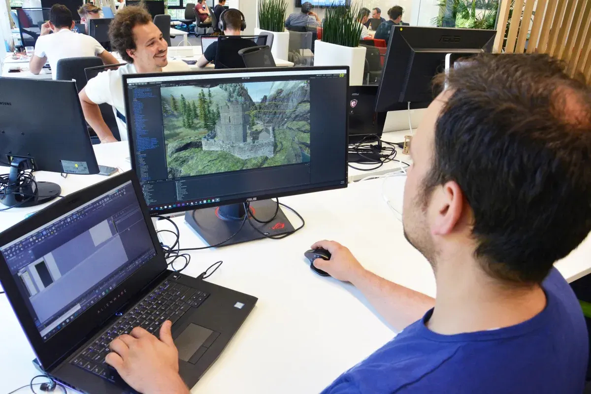 Developer working on the virtual mountain environment at a workstation.